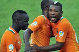 Ivory Coast's National football team players Didier Zokora (C) and Geoffroy Die Serey (R) celebrate their goal at the Felix Houphouet-Boigny stadium in Abidjan on March 23, 2013 during their 2014 World Cup qualifying match