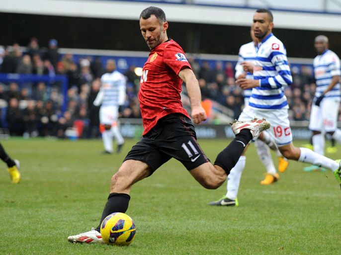 (FILES) In a file picture taken on February 23, 2013 Manchester United's Welsh midfielder Ryan Giggs (L) shoots to score their second goal during the English Premier League football match between Queens Park Rangers and Manchester United at Loftus Road in London. Giggs, who is set to make his 1,000th appearance in senior football this weekend, has signed a new one-year contract at Manchester United, the club announced on March 1, 2013. AFP PHOTO/OLLY GREENWOOD