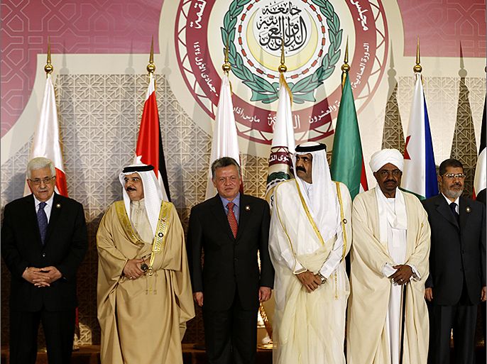 (L-R) Palestinian president Mahmud Abbas, Bahrain's King Hamad bin Issa al-Khalifa, Jordan's King Abdullah II, Qatar's Emir Hamad bin Khalifa al-Thani, Sudanese President Omar al-Bashir and Egyptian President Mohamed Morsi pose for a picture at the opening of the Arab League summit in the Qatari capital Doha on March 26, 2013. The Arab League kicked off a two-day summit in Doha where opponents of President Bashar al-Assad will represent Syria for the first time, despite rifts which have marred their political gains. AFP PHOTO/KARIM SAHIB