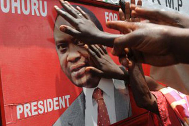 Supporters of Kenyan presidential candidate Uhuru Kenyatta touch his picture on an election poster as they celebrate upon learning of his victory in Kenya's national elections on March 9, 2013 in Kiambu, north of Nairobi- getty images