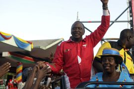 The National Alliance (TNA) presidential candidate Uhuru Kenyatta (C) is greeted as he arrives to address at a rally on March 2, 2013 in Nairobi on the last day of campaigning, 48 hours ahead of presidential, gubernatorial and senatorial elections.