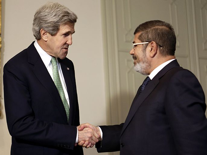 US Secretary of State John Kerry (L) shakes hands with Egyptian President Mohamed Morsi during a meeting at the presidential palace in Cairo on March 3, 2013. Kerry met the Egyptian president as he wrapped up a trip to Cairo, where he urged divided factions to reach a consensus that would pave the way for economic recovery. AFP PHOTO/POOL/JACQUELYN MARTIN