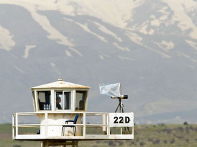 A UN peacekeeper keeps watch from an observation tower in the largely abandoned city of Quneitra, in the demilitarized United Nations Disengagement Observer Force (UNDOF) zone, in the Golan Heights on March 07, 2013. Syrian rebels kept 21 UN peacekeepers hostage on the Golan Heights despite world condemnation of the spillover of Syria's conflict onto the sensitive armistice line with Israel. AFP PHOTO/JACK GUEZ
