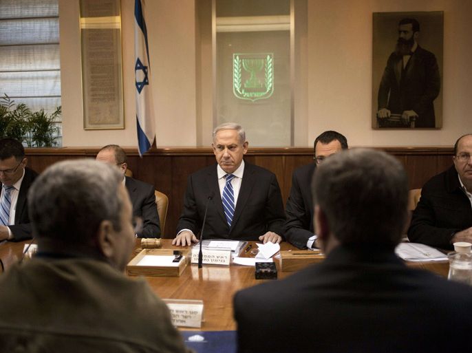 Israeli Prime Minister Benjamin Netanyahu (C) attends the weekly cabinet meeting in his Jerusalem office, on March