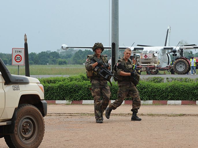 French soldiers patrol on March 25, 2013 at Bangui airport. The UN Security Council will hold urgent talks on March 25 after a bloody coup in Central Africa sent ousted leader Francois Bozize fleeing across the border, and left 13 South African soldiers dead. Seleka coalition rebels seized the capital Bangui on March 24 after the collapse of a two-month-old peace deal with Bozize's regime. Bangui was on edge on March 25 as residents waited for a formal statement by rebel leader Michel Djotodia declaring himself president. AFP PHOTO / SIA KAMBOU