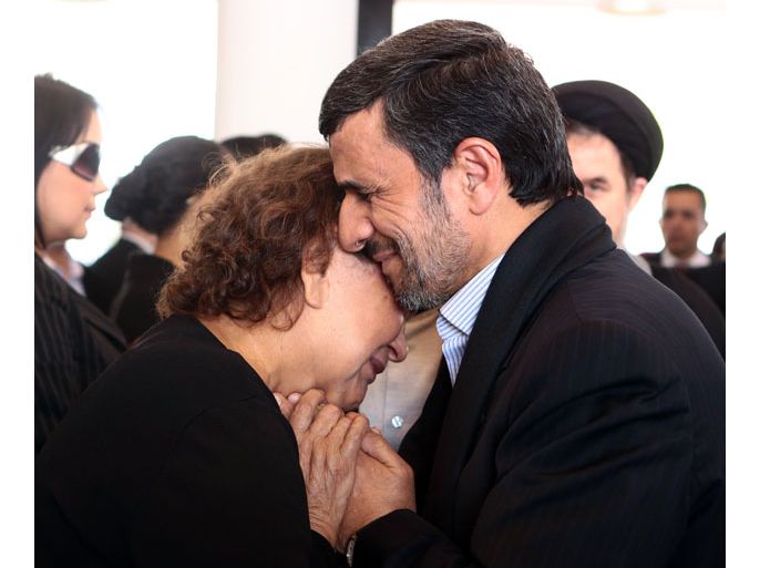VENEZUELA : Handout picture released by the Venezuelan presidency press office showing Iran's President Mahmoud Ahmadinejad (R) offering his condolences to the mother of late Venezuelan President Hugo Chavez, Elena Frias, during his funeral in Caracas, on March 8, 2013. The picture caused controversy among social media who considered Ahmadinejad's way of giving his condolences to Chavez' mother was quite inappropiate for he violated Islamic