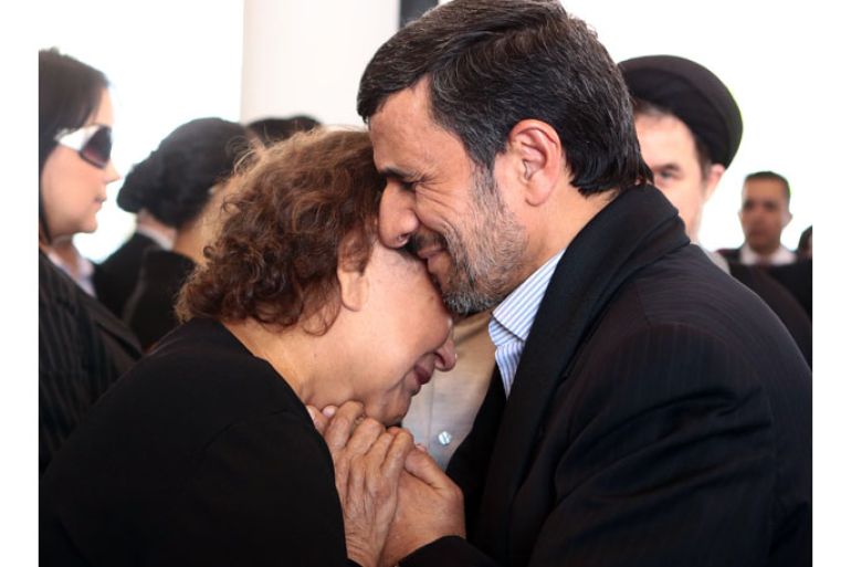VENEZUELA : Handout picture released by the Venezuelan presidency press office showing Iran's President Mahmoud Ahmadinejad (R) offering his condolences to the mother of late Venezuelan President Hugo Chavez, Elena Frias, during his funeral in Caracas, on March 8, 2013. The picture caused controversy among social media who considered Ahmadinejad's way of giving his condolences to Chavez' mother was quite inappropiate for he violated Islamic