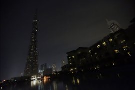 KS449 - Dubai, -, UNITED ARAB EMIRATES : The lights on the Burj Khalifa tower (L) are switched off for an hour in Downtown Dubai, on March 23, 2013, as iconic landmarks and skylines are plunged into darkness as the "Earth Hour" switch-off of lights around the world got under way to raise awareness of climate change. AFP PHOTO/KARIM SAHIB