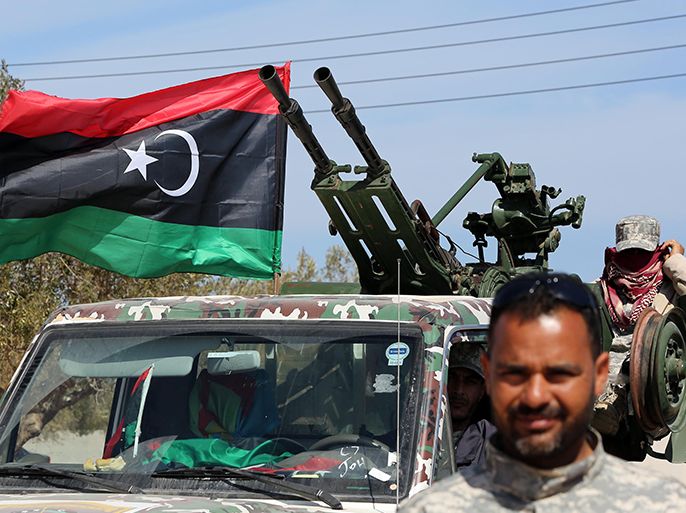 Libyan defence forces patrol outside the Millitah Oil and Gas installation on March 4, 2013 on the outskirts of Zwara in Western Libya. The delivery of Libyan gas to Italy via the Greenstream pipeline was halted on March 3, 2013 after a gunfight between former rebels near a gas complex in the west of the country, an official said. Millitah Oil and Gas is a joint venture between Italy's ENI and Libya's National Oil Company. The Greenstream pipeline runs from Millitah in Libya to Gela in Sicily. AFP PHOTO/MAHMUD TURKIA