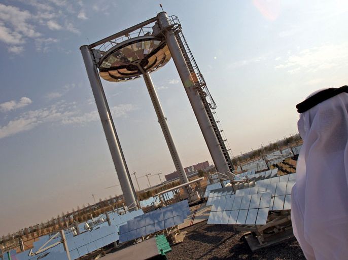 epa02532010 An image dated 10 January 2011 and made available 16 January 2011 showing A UAE man is seen close to the solar 'beam down' R&D project at Masdr City, that is aimed to champion renewable energy technologies in Abu Dhabi, United Arab Emirates on 10 January 2011. The core of the project is a planned city, which is being built by the Abu Dhabi Future Energy Company, a subsidiary of Mubadala Development Company, with the majority of seed capital provided by the government of Abu Dhabi. Designed by the British architectural firm Foster + Partners, the city will rely entirely on solar energy and other renewable energy sources, with a sustainable, zero-carbon, zero-waste ecology. The city is being constructed 17 kilometres (11 mi) east-south-east of the city of Abu Dhabi. EPA/ALI HAIDER