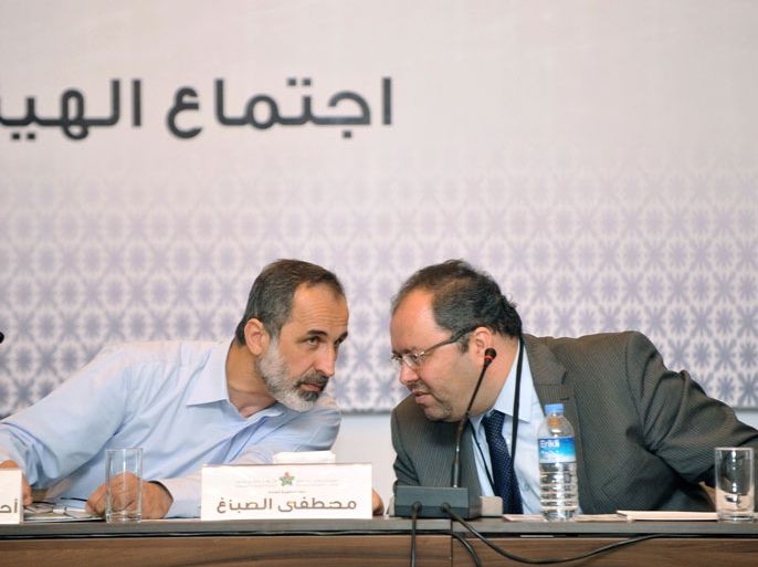 TURKEY : Syrian opposition's National Coalition chief Ahmed Moaz al-Khatib (L) and Mostafa Sabbah(R) talk during the Syria's opposition coalition meeting at on March 18, 2013 in Istanbul to choose their first prime minister, tasked with running daily life in large swathes of territory freed from regime control but mired in chaos and poverty. AFP PHOTO/OZAN KOSE