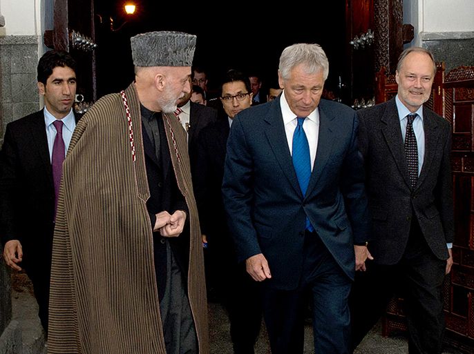 This US Department of Defense handout image provide March 10, 2013 shows US Secretary of Defense, Chuck Hagel(2nd-R), walking with Afghan president Hamid Karzai(L), during a private meeting in Kabul. Karzai Sunday cancelled a high-profile press conference in Kabul with new US Defense Secretary Chuck Hagel, with US officials saying the event was dropped for "security concerns." AFP PHOTO / HANDOUT / DoD / Erin A. Kirk-Cuomo = RESTRICTED TO EDITORIAL USE - MANDATORY CREDIT " AFP PHOTO / DoD / Erin A. Kirk-Cuomo " - NO MARKETING NO ADVERTISING CAMPAIGNS - DISTRIBUTED AS A SERVICE TO CLIENTS =
