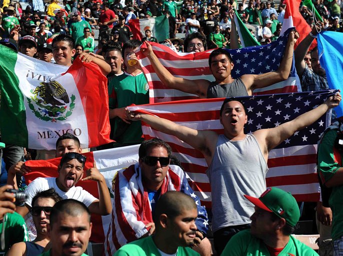 epa02795861 Fans wave US and Mexico flags prior to the start of the Mexico vs USA Gold Cup soccer final match at the Rose Bowl in Pasadena California USA 25 June 2011. EPA/MIKE NELSON
