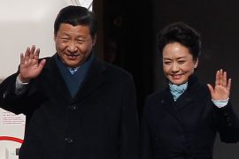 Chinese President Xi Jinping (L) and First Lady Peng Liyuan wave as they disembark from a plane upon their arrival at Moscow's Vnukovo airport March 22, 2013. REUTERS/Maxim Shemetov (RUSSIA - Tags: POLITICS TRANSPORT)