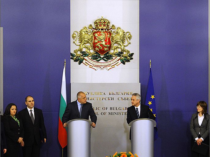 Bulgarian interim Prime Minister-designate Marin Raykov (R), outgoing Prime Minister Boyko Borisov (L) and their governments attend on March 13, 2013 the official ceremony of transfer of power of the new government in Sofia. After weeks of protests, Bulgaria's new technocrat caretaker government must urgently restore trust in state institutions or risk exacerbating an already dire economic situation in the European Union's poorest country, analysts say. AFP PHOTO / NIKOLAY DOYCHINOV
