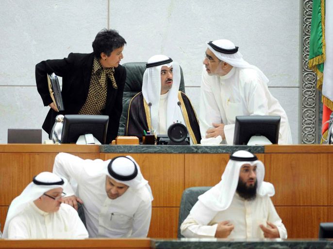 Kuwaiti parliament speaker Ali al-Rashed (C-back) speaks with Kuwaiti member of parliament (MP) Adnan Abdulsamad (R-back) and MP Safaa al-Hashem (L-back) during a parliament session to discuss the delay in the building of houses in the wealthy Gulf sate at Kuwait's national assembly in Kuwait City on March 7, 2013. Kuwait plans to build around 174,000 housing units by 2020 for citizens, housing minister Salem al-Othaina told parliament, in projects that will cost billions of dollars. AFP