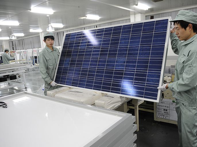 To go with China-US-solar-company-distress-Suntech,FOCUS by Bill Savadove This picture taken on February 27, 2012 shows workers assembling solar panels on the factory floor of Chinese company Suntech in the eastern Chinese city of Wuxi. China's Suntech has made a painful journey from being the world's largest solar panel producer to flirting with bankruptcy in just a year, highlighting the woes of the industry it shaped. AFP PHOTO / Peter PARKS