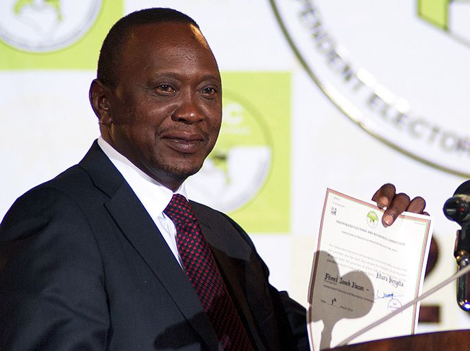 Uhuru Kenyatta shows a certificate confirming him as Kenya's new President elect received from Isaack Hassan (out of frame), Chairman of the Independent Electoral and Boundaries Commission (IEBC) at Bomas, in Nairobi, on March 9th 2013. Uhuru emerged as winner of the 2013 general election by a slim margin, and the opposing CORD Coalition have said they will contest the result. AFP Photo/Will Boase AFP PHOTO / WILL BOASE