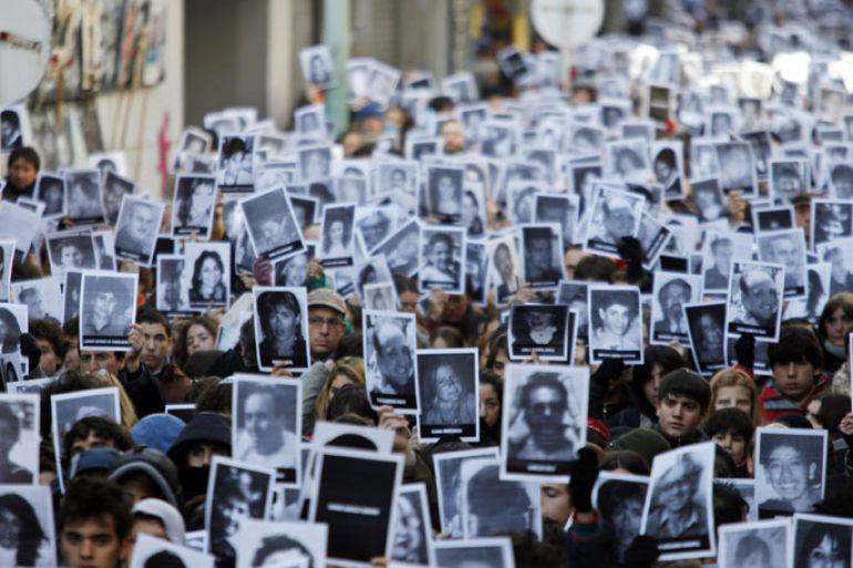 People holding photographies of victims participate at the ceremony to mark the 16th anniversary of the bomb attack against the Jewish Community Center (AMIA) in Buenos Aires, Argentina, 16 July 2010. The bombing, on July 18, 1994, caused the seven-story building of the Jewish-Argentine Mutual Association community center in Buenos Aires to collapse, killing 85 people and injuring another 300.