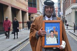 Mizal Karim Al-Sweady holds a photograph of his dead son Hamid Al-Sweady after giving evidence to the Al-Sweady Inquiry in London March 18, 2013. The inquiry is looking into allegations that, after a firefight with British soldiers in Iraq in 2004, Iraqi nationals were detained and unlawfully killed at a British camp, and that others had been mistreated at that camp, and also at a detention facility