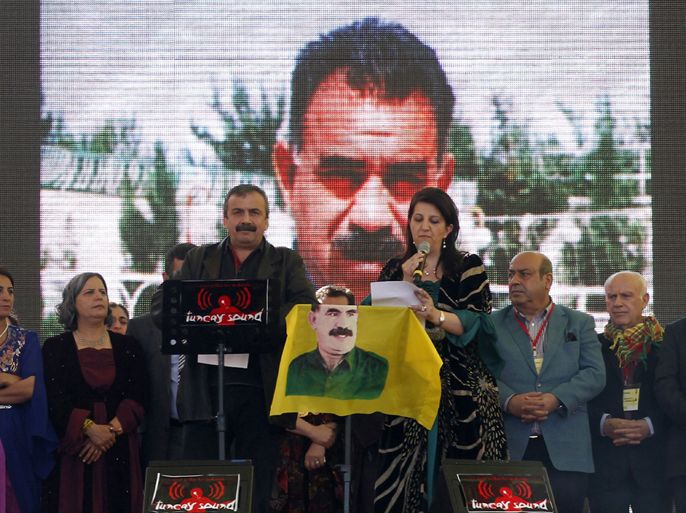 Diyarbakir, Diyarbakir, TURKEY : Pro-Kurdish politicians Sirri Sureyya Onder (L) and Pelvin Buldan (R) read jailed Kurdish rebel chief Abdullah Ocalan's message on March 21, 2013, in the southern Turkish city of Diyarbakir. The festival is celebrated in Turkey, Central Asian republics, Iraq, Iran, Azerbaijan as well as war-torn Afghanistan and coincides with the astronomical vernal equinox. The festival is celebrated in Turkey, Central Asian republics, Iraq, Iran, Azerbaijan as well as war-torn Afghanistan and coincides with the astronomical vernal equinox. Jailed Kurdish rebel chief Abdullah Ocalan called on March 21 for a ceasefire, telling militants to lay down their arms and withdraw from Turkish soil, raising hopes for an end to a three-decade conflict with Turkey that has cost tens of thousands of lives. AFP PHOTO