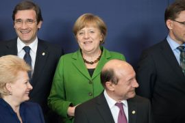 Brussels, -, BELGIUM : (1st row L-R) Lithuanian President Dalia Grybauskaite, Romanian President Traian Basescu, (2nd row L-R) Portuguese Prime Minister Pedro Passos Coelho, German Chancellor Angela Merkel and Finnish Prime Minister Jyrki Katainen pose during the family photo at the EU Headquarters on March 14, 2013 in Brussels, on the first day of a two-day European Union leaders summit. European Union leaders try Thursday to find a difficult balance between austerity policies adopted to cut debt and calls to spend more to generate growth and jobs in an economy stuck in the doldrums. BERTRAND LANGLOIS