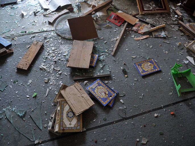 MYANMAR : Torn religious books lie on the floor of a partially-destroyed mosque after sectarian violence spread through central Myanmar, in Minhla, Bago division on March 28, 2013. Myanmar's Muslim leaders have appealed to President Thein Sein to take swift action to quell religious violence