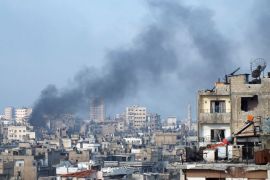Smoke rises from one of the buildings in the city of Homs March 11, 2013. Picture taken March 11, 2013. REUTERS/Yazan Homsy (SYRIA - Tags: CONFLICT POLITICS CIVIL UNREST)