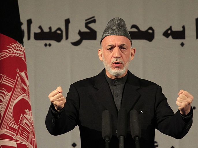 epa03617540 Afghan President Hamid Karzai speaks during an event commemorating International Women's Day, in Kabul, Afghanistan, 10 March 2013. International Women's Day was marked around the world on 08 March. Afghanistan has made some progress in applying three-year-old legislation that criminalizes violence against women, but gaps in implementation remain, the United Nations said on 11 December 2012. EPA/S. SABAWOON