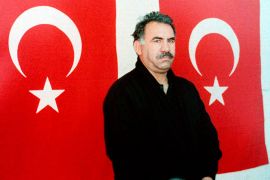 Kurdish rebel leader Abdullah Ocalan poses in front of Turkish flags after he arrived at the prison island of Imrali, in the Marmara Sea in this February 18, 1999 file photo. The Kurdistan Workers Party (PKK), whose leader Abdullah Ocalan is conducting talks from his prison cell on an island near Istanbul, is expected to declare a ceasefire the week of March 18, 2013. On March 13, 2013, the PKK freed a group of Turkish soldiers held prisoner in their mountain retreat in northern Iraq. Previous contact with the man once dubbed "baby killer" by Turkish media was a closely-guarded secret, but the latest talks have been openly acknowledged by Ankara, risking the wrath of a conservative establishment. To match Insight TURKEY-KURDS/ REUTERS/Handout/Files (TURKEY - Tags: POLITICS CRIME LAW) FOR EDITORIAL USE ONLY. NOT FOR SALE FOR MARKETING OR ADVERTISING CAMPAIGNS. THIS IMAGE HAS BEEN SUPPLIED BY A THIRD PARTY. IT IS DISTRIBUTED, EXACTLY AS RECEIVED BY REUTERS, AS A SERVICE TO CLIENTS