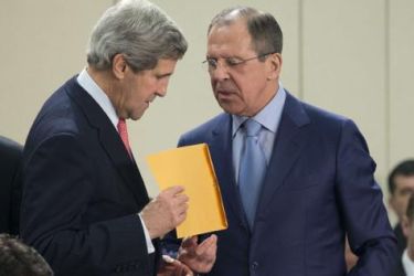 Russian Foreign Minister Sergei Lavrov (R) hands a folder to US Secretary of State John Kerry before a Nato Russia Foreign Affairs ministers meeting at the Nato Headquarters in Brussels on April 23, 2013. AFP PHOTO POOL EVAN VUCCI