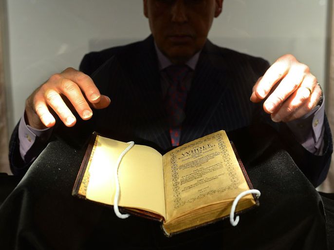 Sotheby’s employee handles a copy of the “Bay Psalm Book”, the first book printed in what is now the US in 1640 and is considered the world’s most valuable book, with an auction estimate of 15 to 30 million USD, during a preview at Sotheby’s in New York, April 12, 2013. The first edition of the Bay Psalm Book was printed by Congregationalist Puritans in Cambridge, Massachusetts, in 1640, and Sotheby’s will auction one of the 11 surviving copies, on November 26, 2013