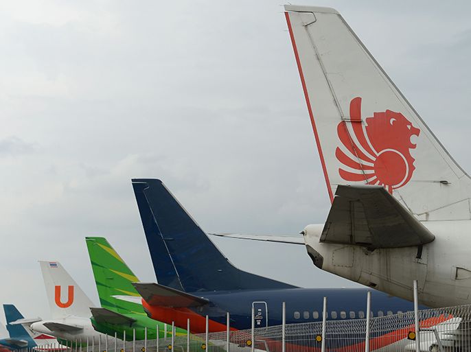 This picture taken on April 4, 2013 in Tangerang shows tails of Lion Air plane (1st R) with others planes parked at the hangar of the Sukarno-Hatta airport in Tangerang. A new rivalry between the worlds's biggest planemakers is heating up in Indonesia after a record deal for Airbus in a market with huge potential that until now has been a "fortress" for Boeing. Indonesians are increasingly relying on air travel to link the archipelago of 17,000-odd islands, with up to 900 new planes set to be delivered to Indonesia in the next decade, according to the government. The potential is massive -- only six percent of Indonesians have travelled by air, according to officials, in a nation of 240 million people that has consistently clocked annual economic growth above six percent. AFP PHOTO / ADEK BERRY