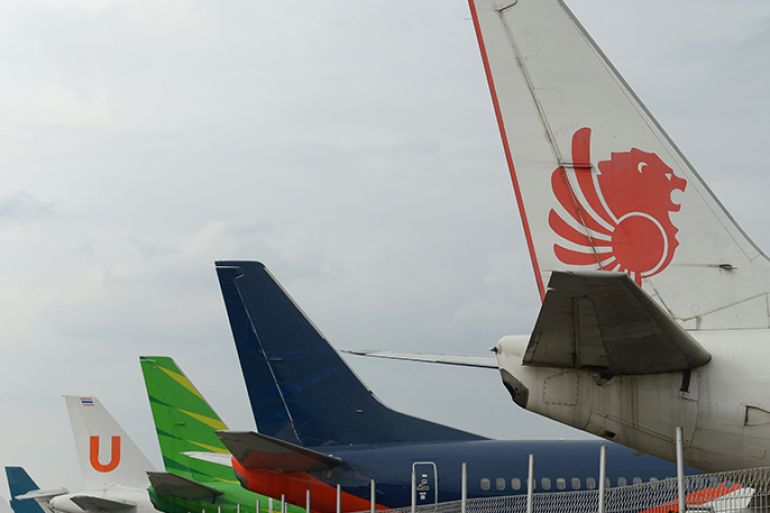 This picture taken on April 4, 2013 in Tangerang shows tails of Lion Air plane (1st R) with others planes parked at the hangar of the Sukarno-Hatta airport in Tangerang. A new rivalry between the worlds's biggest planemakers is heating up in Indonesia after a record deal for Airbus in a market with huge potential that until now has been a "fortress" for Boeing. Indonesians are increasingly relying on air travel to link the archipelago of 17,000-odd islands, with up to 900 new planes set to be delivered to Indonesia in the next decade, according to the government. The potential is massive -- only six percent of Indonesians have travelled by air, according to officials, in a nation of 240 million people that has consistently clocked annual economic growth above six percent. AFP PHOTO / ADEK BERRY