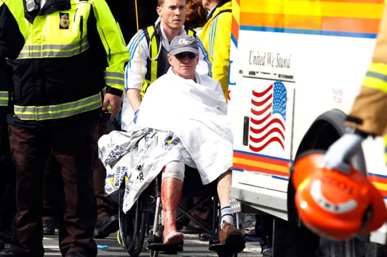 A runner in a wheelchair is taken from a triage tent after explosions went off at the 117th Boston Marathon in Boston, Massachusetts April 15, 2013. Two explosions hit the Boston Marathon as runners crossed the finish line on Monday, killing at least two people and injuring 23 on a day when tens of thousands of people