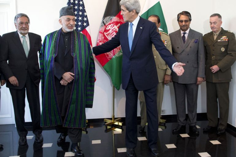 US Secretary of State John Kerry, centre, escorts Afghan President Hamid Karzai, second left, into a meeting on April 24, 2013, in Brussels. The trilateral meeting is to discuss regional security issues, and the 2014 withdrawal of NATO combat forces from Afghanistan. From left, Afghan Defence Minister Bismellah Mohammadi, Karzai, John Kerry, Pakistani Army Chief Gen. Asfhaq Parvez Kayani, Afghan Foreign Secretary Jalil Abbas Jilani, and US Gen. Joseph Dunford