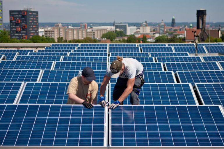 epa03434116 (FILE) A file photo dated 31 May 2011 showing two fitters working on a solar system on the roof of the Technical University's Gerber house in Dresden, Germany. Germany increased a surcharge on the retail price of electricity by 47 per cent 15 October 2012 to pay for the planned phasing out of nuclear power, prompting criticism from the government's junior coalition partner. The surcharge will increase to 5.277 cents per kilowatt-hour of electricity next year, the four national power grid companies announced in Berlin. Last year, Germany decided to shut down all its 17 nuclear power reactors within a decade, following public alarm at the partial meltdowns of reactors in Fukushima, Japan after an earthquake and tsunami. Previously, a quarter of German power came from nuclear plants. EPA/OLIVER KILLIG