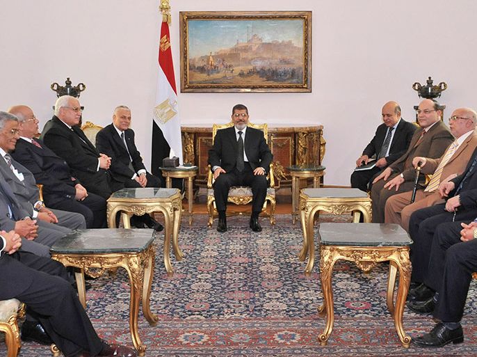 Egypt's President Mohamed Mursi (C) meets with the Supreme Judicial Council and the prosecutor general to discuss a draft law reforming the judiciary due to go through the Islamist-dominated upper house at El-Thadiya presidential palace in Cairo April 22, 2013. Mursi held crisis talks with the country's top judges on Monday after the justice minister resigned over demands by the ruling Muslim Brotherhood for a "purification" of the judiciary. REUTERS/Egyptian Presidency/Handout (EGYPT - Tags: POLITICS) ATTENTION EDITORS - THIS IMAGE WAS PROVIDED BY A THIRD PARTY. THIS PICTURE IS DISTRIBUTED EXACTLY AS RECEIVED BY REUTERS, AS A SERVICE TO CLIENTS