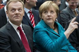 German Chancellor Angela Merkel (R) and Polish Prime Minister Donald Tusk (L) chat prior to the start of a discussion on Europe in Berlin April 22, 2013. The discussion coincides with the release of a biography of Merkel by German journalist and author Stefan Kornelius, titled "Angela Merkel - The Chancellor and her World" (Angela Merkel - Die Kanzlerin und ihre Welt). AFP PHOTO / JOHN MACDOUGALL