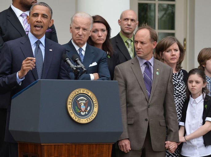 : US President Barack Obama is accompanied by vice president Joe Biden (2nd-L) and family members of Newtown school shooting victims as he speaks on gun control at the Rose Garden of the White House in Washington, DC, on April 17, 2013. Obama on Wednesday slammed what he called a "minority" in the US Senate for blocking legislation that would have expanded background checks on those seeking to buy guns