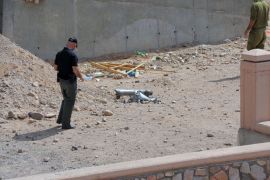 An Israeli policeman inspects the site of a rocket explosion in the Israeli Red Sea resort of Eilat April 17 2013. A Salafi jihadist group claimed responsibility for firing what it said were Grad rockets at Eilat, causing no damage or casualties.