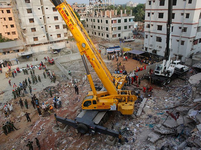 Army soldiers clear up the rubble of the collapsed Rana Plaza building with a crane in Savar, 30 km (19 miles) outside Dhaka April 28, 2013. The owner of a factory building that collapsed in Bangladesh killing hundreds of garment workers was arrested on Sunday trying to flee to India, as hopes of finding more survivors from the country's worst industrial accident began to fade. Authorities put the latest death toll at 377 and expect it to climb higher with hundreds more still unaccounted for. REUTERS/Andrew Biraj (BANGLADESH - Tags: DISASTER)