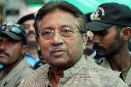 Former Pakistani president Pervez Musharraf (C) is escorted by soldiers as he arrives at an anti-terrorism court in Islamabad on April 20, 2013. Pakistan's former military ruler Pervez Musharraf on April 20 appeared before an anti-terrorism court after spending the night at police headquarters, officials said. He was moved into police custody after being arrested on April 19, an unprecedented move against a former army chief of staff ahead of key elections. The arrest relates to Musharraf's decision to sack judges when he imposed emergency rule in November 2007, a move which hastened his downfall. AFP PHOTO / AAMIR QURESHI