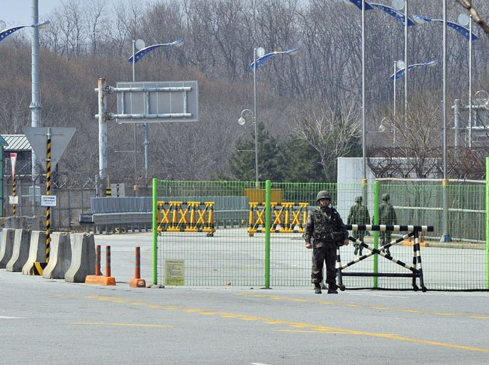 South Korean soldiers stand on the empty road as trucks returned back after they were banned access to Kaesong joint industrial park in North Korea, at a military check point of the inter-Korean transit office in Paju on April 3, 2013. North Korea blocked South Korean access to a key joint industrial zone on April 3, in a sharp escalation of tensions as Washington condemned Pyongyang's "dangerous, reckless" behaviour.