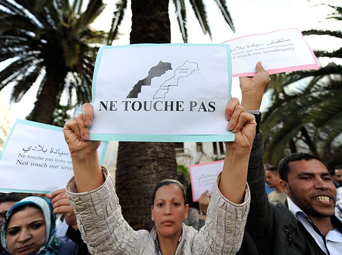 Moroccans hold signs during a protest against U.S.-backed plans to broaden the mandate of UN peacekeepers in the disputed Western Sahara, in Casablanca April 22, 2013. The sign reads, "Do not Touch". REUTERS/Youssef Boudlal (MOROCCO - Tags: CIVIL UNREST POLITICS)