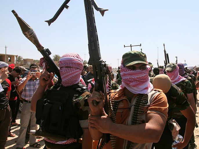 Iraqi anti-government gunmen from Sunni tribes in the western Anbar province march during a protest in Ramadi, west of Baghdad, on April 26, 2013. The United Nations warned that Iraq is at a "crossroads" and appealed for restraint, as a bloody four-day wave of violence killed 195 people. The violence is the deadliest so far linked to demonstrations that broke out in Sunni areas of the Shiite-majority country more than four months ago, raising fears of a return to all-out sectarian conflict. AFP PHOTO/AZHAR SHALLAL