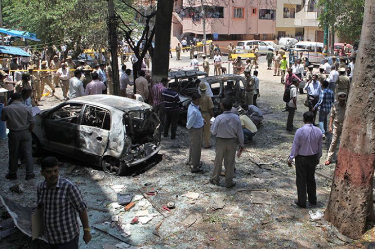 Indian police gather at the scene of a blast near the Bharatiya Janata Party (BJP) office in Bangalore on April 17, 2013. Police in the southern city of Bangalore said Wednesday they were investigating a minor blast outside the office of a political party which injured 12 people. AFP PHOTO/STR