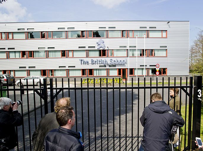 The media gather in front of the British School in Voorschoten, The Netherlands, on April 22, 2013. Dutch police arrested a former pupil at a British school in the Netherlands on Monday in connection with a threat to go on a shooting spree that saw armed police deployed and schools closed. Police in the university city of Leiden, just northeast of The Hague, confirmed one person had been arrested following the threat to 'shoot my Dutch teacher and as many students as I can', made on an Internet site over the weekend. Date Published: April 22, 2013 Credit: AFP/Getty Images Byline/Author: MARCEL ANTONISSE Keywords: Assembling, Education, The Media