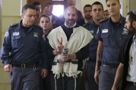American-born Israeli settler Yaakov (Jack) Teitel flashes the "V" for victory sign as he arrives for his trial at the Jerusalem District Court on April 9, 2013. An Israeli court sentenced the extreme rightwing US-born Jewish settler to two life terms in prison for the murder of two Palestinians in 1997. Teitel, 41, was found guilty in January of murdering a bus driver and a shepherd as well as two separate attempted murders, for illegal possession of weapons and incitement to violence