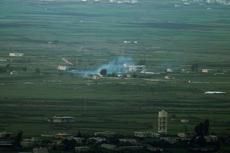 epa03642806 Smoke rises from a Syrian tank located in the demilitarized zoon between Israel and Syria next to the village of Jubata, seen from the Israeli side of the Golan Heights, 27 March 2013. The Israel Defense Forces Chief of Staff allowed local medics to treat seven Syrians rebels wounded who came to the Golan Heights border 27 March, citing humanitarian considerations. EPA/ATEF SAFADI